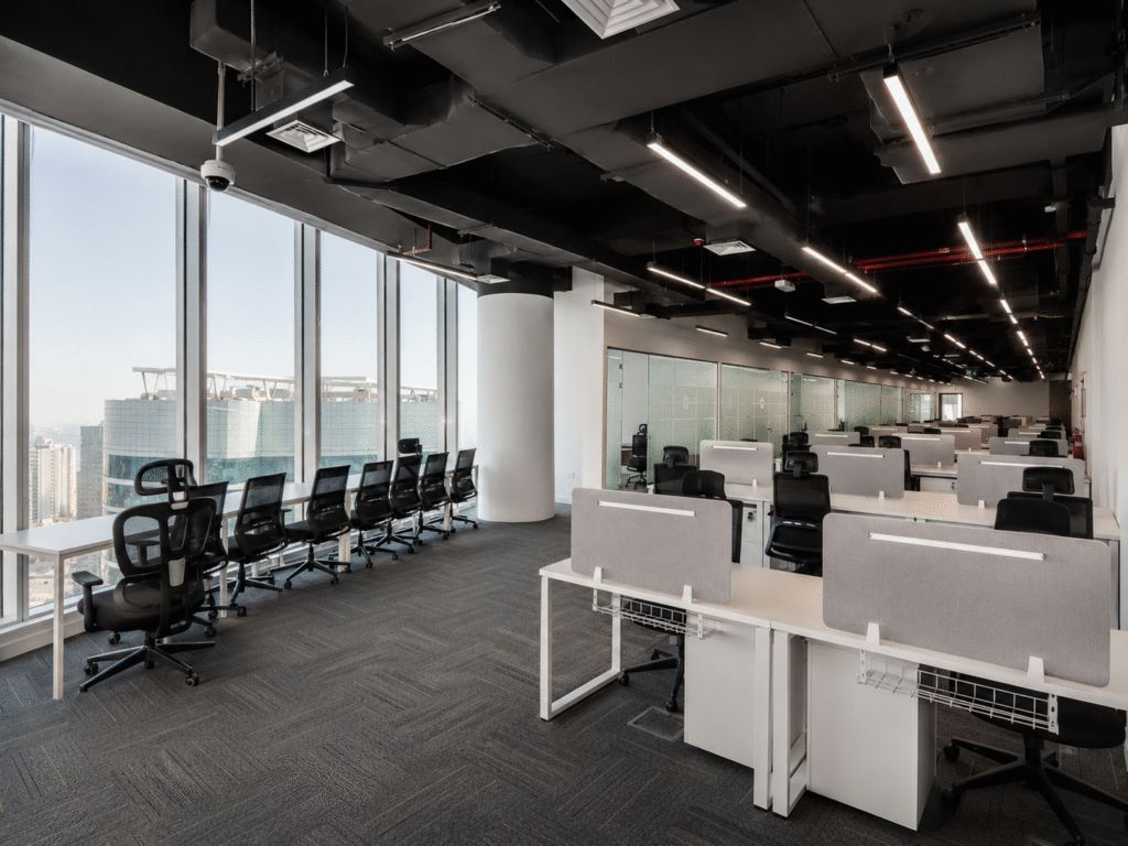 Large-scale corporate office fit-out for ADNOC / CPECC in Abu Dhabi by Esquinas Interiors featuring workstation areas, private offices, meeting rooms, reception design, premium finishes, and complete MEP and joinery works.